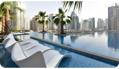 Photo of a housing complex in Dubai, taken by the pool with the buildings in the back.
