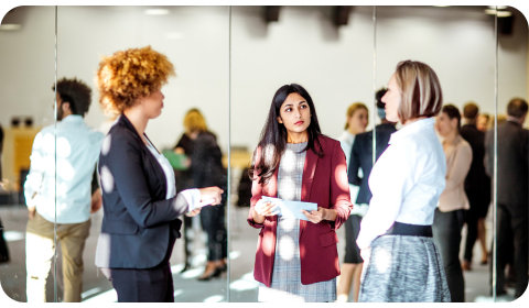 Photo of three women networking at an event.