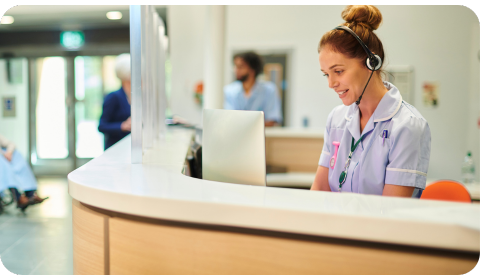 Photo of a receptionist attending calls in a hospital reception